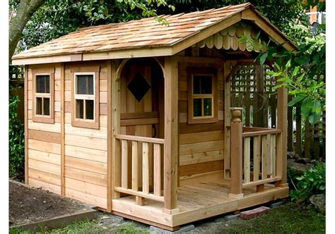 A Small Wooden Shed Sitting Next To A Tree
