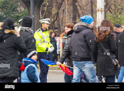 Romanian Police Officer Routing Traffic And Pedestrians Crossing The