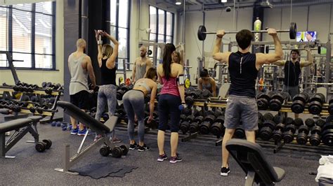 Young People In Gym Working Out With Various Barbells Stock Video