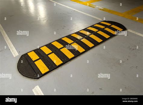 Striped Black And Yellow Speed Bump On A Road Stock Photo Alamy