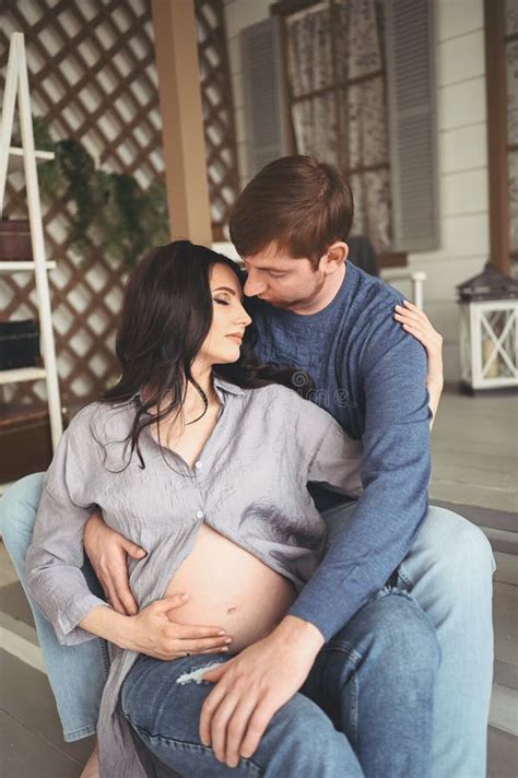 Pregnancy And People Concept Happy Man Hugging His Beautiful Pregnant Wife At Home Future