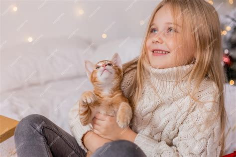 Premium Photo A Girl Holding A Cat In Her Arms