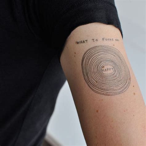 simple homemade black ink circles with lettering tattoo on arm tattooimages