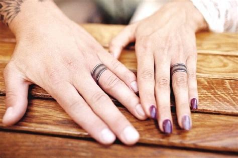 A romantic heart arrow wedding ring tattoos that is 30 awesome ways to show off your engagement ring. Super cool engagement and wedding ring tattoo ideas for ...