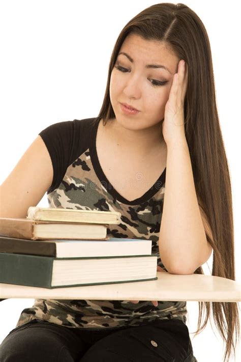 Female Student Sitting At Her Desk Pondering Book Pile Stock Image