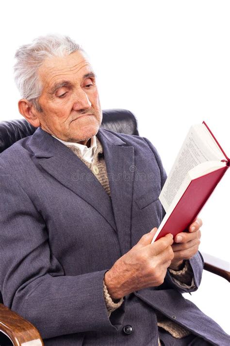 Portrait Of An Old Man Reading A Book Sitting In His Armchair Stock