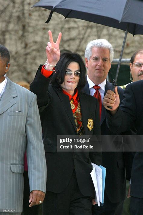 Singer Michael Jackson Gestures While Walking With Attorneys And