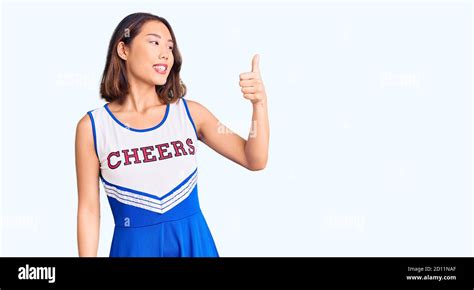 Young Beautiful Chinese Girl Wearing Cheerleader Uniform Looking Proud