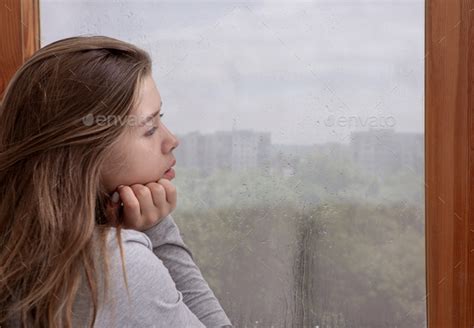 Sad Young Woman Looking Out Window Lost In Thought Copy Space