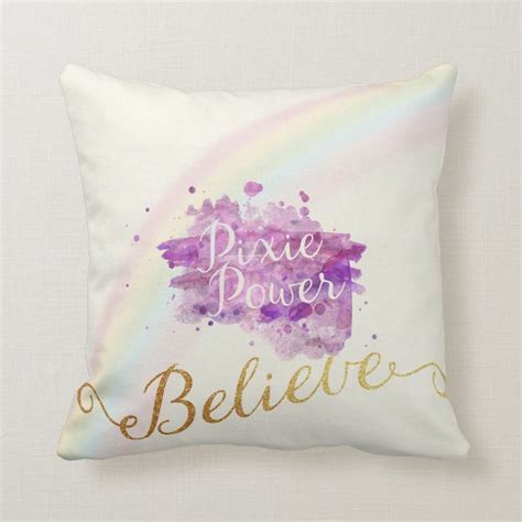 A Pillow With The Words Pixie Power And A Watercolor Rainbow Behind It