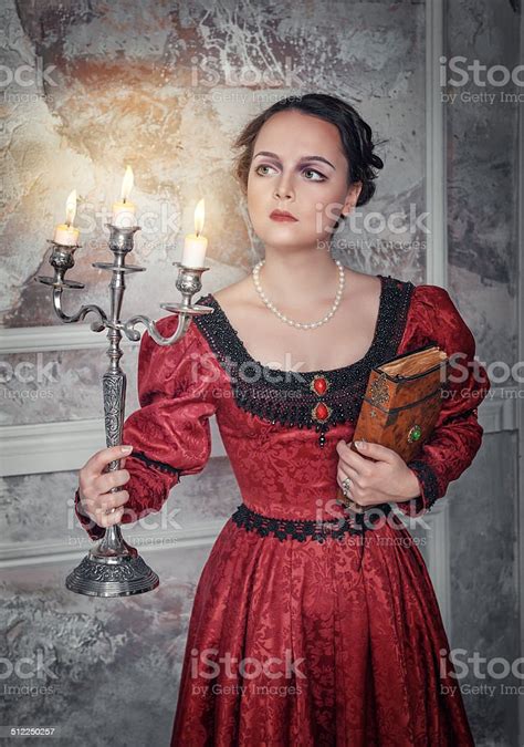 Beautiful Woman In Medieval Dress With Candelabrum Stock Photo