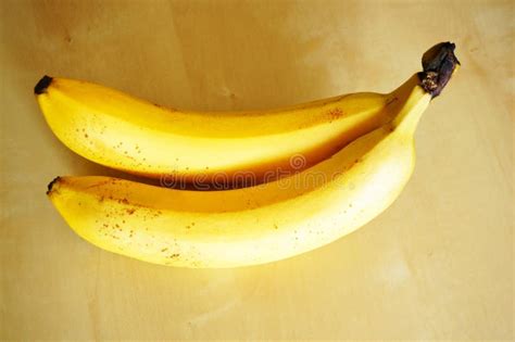 Closeup Shot Of Two Bananas On A Wooden Table Stock Image Image Of