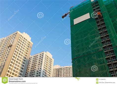 Under Construction Building With Finished Built Buildings Stock Photo