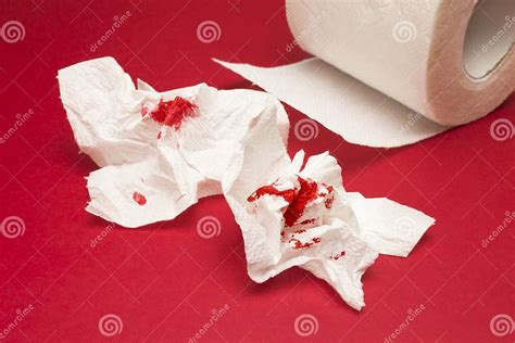 A Photo Of Used Of Bloody Toilet Paper And A Toilet Paper Roll On The