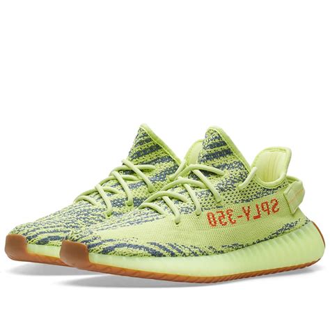 Adidas yeezy is a fashion collaboration between german sportswear company adidas and american designer, rapper, entrepreneur and personality kanye west. Adidas Yeezy Boost 350 V2 Semi Frozen Yellow & Raw Steel | END.
