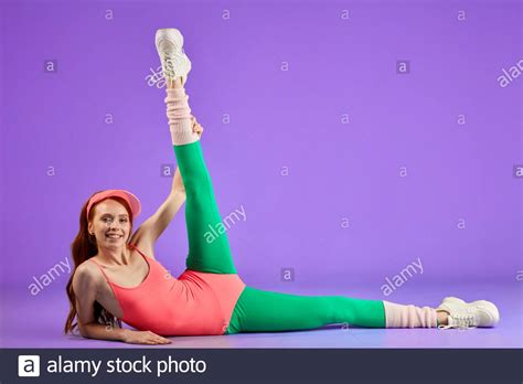 Red Haired Girl In Perfect Shape Shows Her Great Flexibility Doing Stretching Exercises Lying