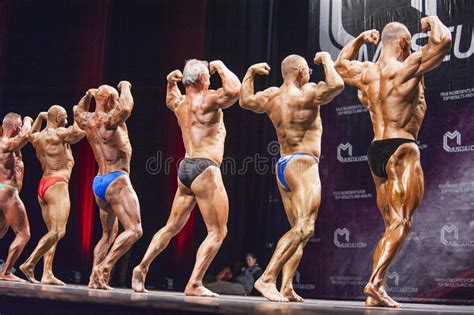 Les Bodybuilders Montrent Leur Pose De Coffre Dans Une Comparaison De Ligne Image Stock