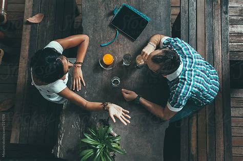 Overhead Shot Of Two Friends In A Cafe By Mosuno Cafe Couple Stocksy United