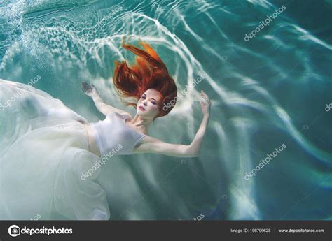 Underwater Girl Beautiful Red Haired Woman In A White Dress Swimming