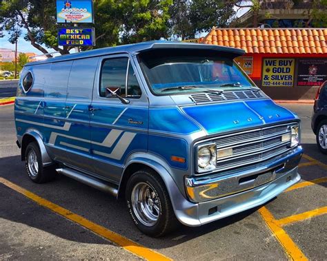 A Blue Van Is Parked In A Parking Lot