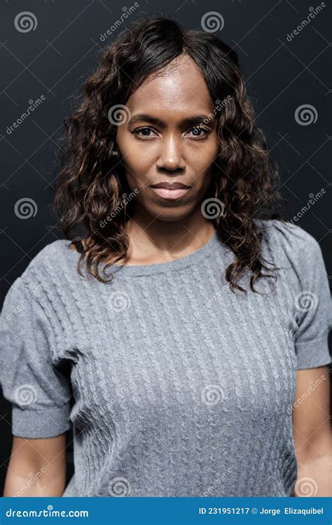 Serious Portrait Of Mature Black Woman With Black Background Stock