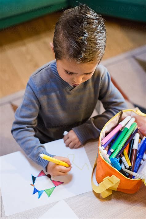 Child Drawing With A Marker At Home Del Colaborador De Stocksy Mauro