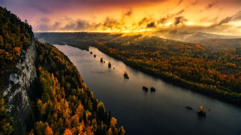 Aerial View Of River And Forest With Background Of Sunset