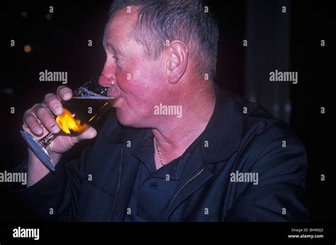 Man With Flushed Red Face From Alcohol Drinking Lager Stock Photo Alamy