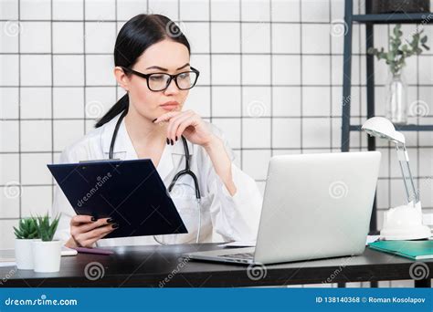 Female Brunette Doctor Wears Glasses Using Tablet Intelligent And Lovely Woman With The Gadget