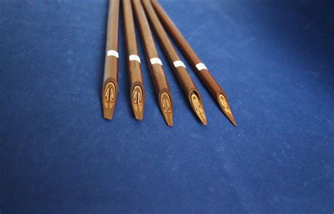 Five Wooden Pencils Lined Up On A Blue Surface
