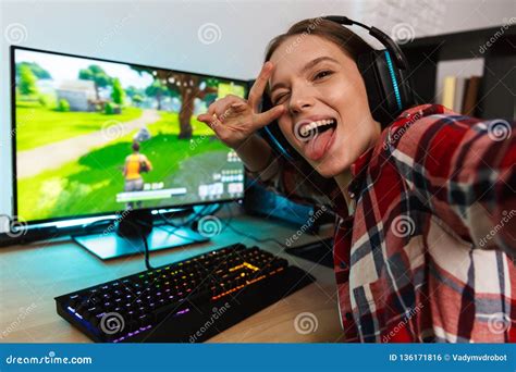 Excited Girl Gamer Sitting At The Table Playing Online Games Stock