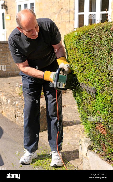 Man Using Hedge Trimmer Hi Res Stock Photography And Images Alamy