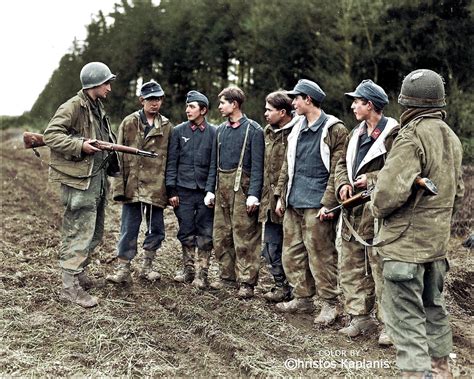 Two GIs of the th Infantry Division guard a group of teenage German POWs near Dausfeld Prüm