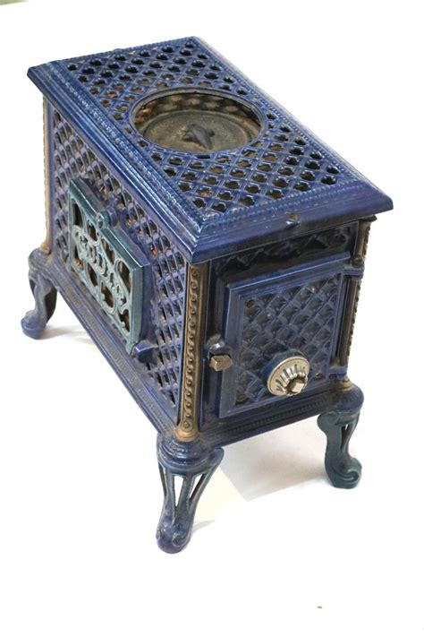 With careful stoking with wood or wood and coal this small fire will burn 'over night'. French Enamel Godin Cast Iron Wood Coal Burning Stove at 1stdibs