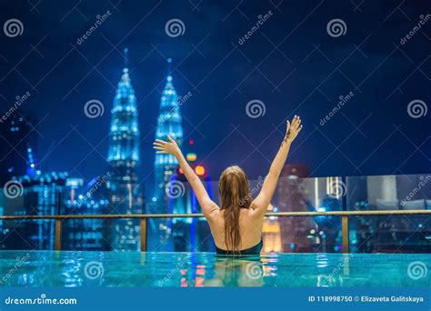 Young Woman In Outdoor Swimming Pool With City View At Night Stock