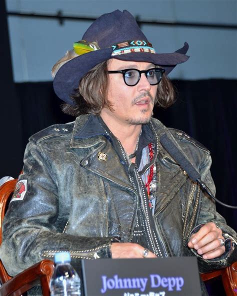 Johnny Depp Sporting A Leather Jacket And A Cowboy Hat Acknowledges