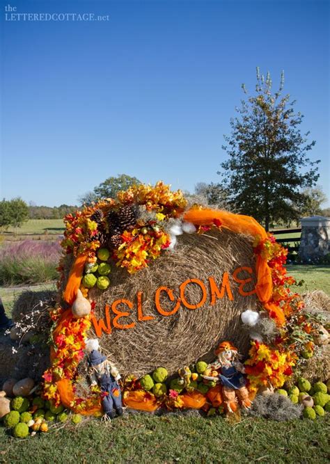 A Hay Bale Decorated With Pumpkins And Flowers