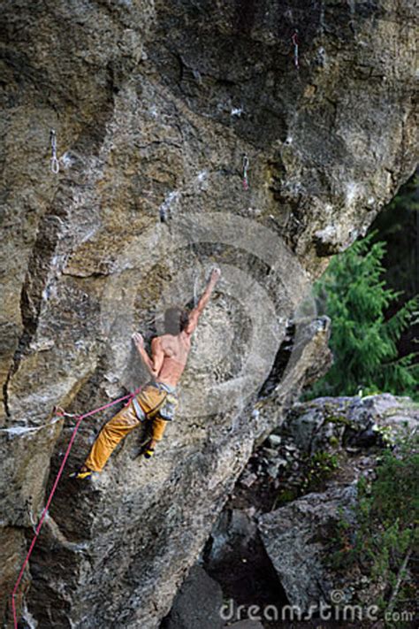 Extreme Sport Climbing Rock Climber On A Face Of A Cliff Stock Photo