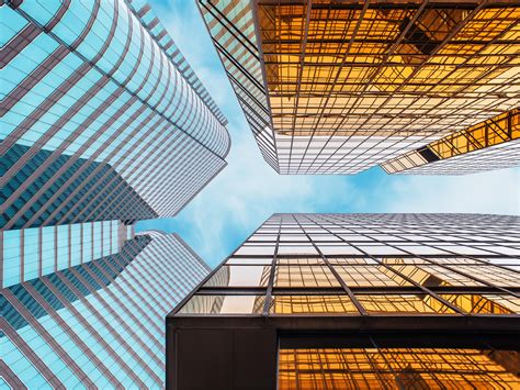 Low Angle Photography Of Glass High Rise Buildings Under Blue Sky And