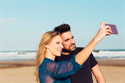 Free Photo Couple Taking Selfie On Beach