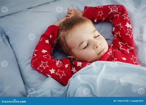 Sleepy Boy Lying In Bed With Blue Beddings Tired Child In Bedroom