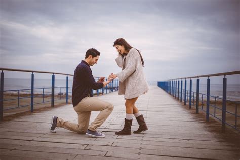 Man On One Knee Proposing To Girlfriend On A Pier For Your Marriage