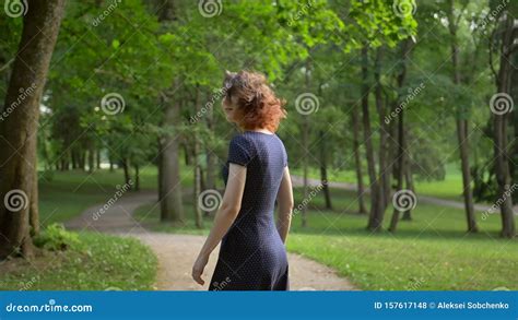 Middle View Of Young Beautiful Girl Unfolding Into The Camera In The Park Stock Footage Video