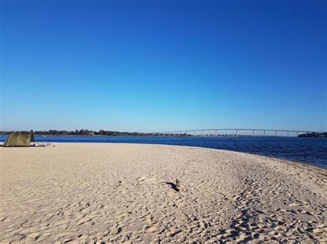 Beach And Water And Bridge At Solomons Island Maryland With Tent