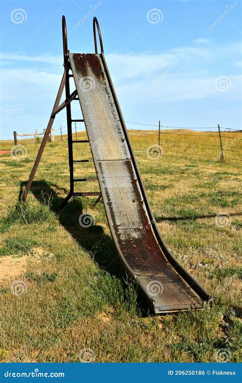 Old Slippery Slide Remains In A Rural Playground Setting Stock Photo
