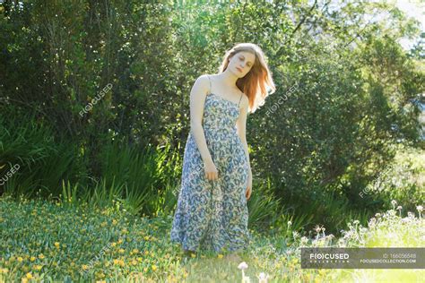 Teenage Girl Standing In Field Of Flowers — Sunlight Soft Stock