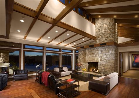 Traditional living room with wooden ceiling beams and bright blue sofas [from: Vaulted Ceilings Pros and Cons