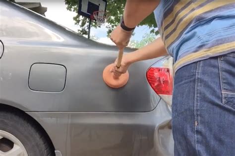 Watch As A Man Demonstrates How To Remove Dents From A Car Yourself Aol