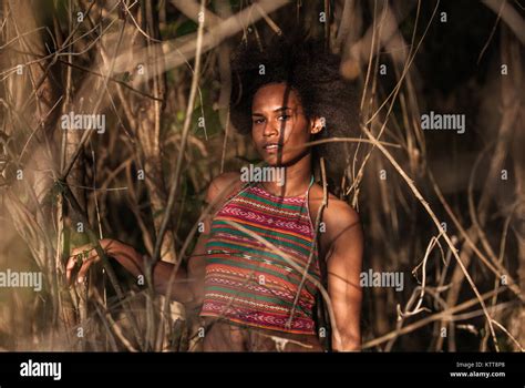 melanesian pacific islander athlete girl with afro hair sytile in the jungle half profile stock