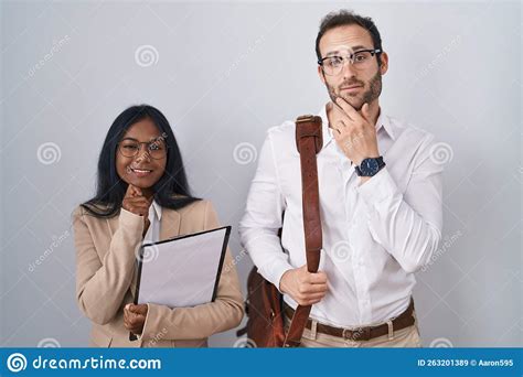 Interracial Business Couple Wearing Glasses With Hand On Chin Thinking About Question Pensive